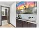 Chic wet bar area with a sink, marble countertop, and views of the main bedroom at 1744 E Luke Ave, Phoenix, AZ 85016