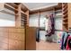 Walk-in closet with custom shelving, drawers, and ample hanging space for organization at 18140 N Saddle Ridge Dr, Surprise, AZ 85374