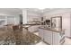 Open concept kitchen with granite counters, stainless steel appliances, and ample cabinet space at 18140 N Saddle Ridge Dr, Surprise, AZ 85374