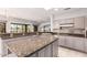 Bright kitchen showcasing granite countertops, tile backsplash, and modern appliances at 18140 N Saddle Ridge Dr, Surprise, AZ 85374