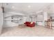 Open living room with tile floors, modern decor, and seamless access to the kitchen area at 18140 N Saddle Ridge Dr, Surprise, AZ 85374