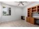 Comfortable office space offering built-in desk and shelving with natural light from the window at 18140 N Saddle Ridge Dr, Surprise, AZ 85374