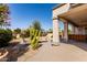 Covered patio with desert landscaping, seating, and decorative columns at 18140 N Saddle Ridge Dr, Surprise, AZ 85374