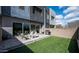 Relaxing backyard with artificial grass, patio, and modern outdoor grill at 1953 W Kinfield Trl, Phoenix, AZ 85085