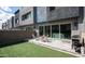 Cozy backyard features synthetic lawn, paved patio, and outdoor seating at 1953 W Kinfield Trl, Phoenix, AZ 85085