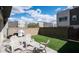 Serene backyard with synthetic turf, a patio, and BBQ grill perfect for outdoor living at 1953 W Kinfield Trl, Phoenix, AZ 85085