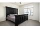 Comfortable bedroom featuring a large bed frame and a well-lit window at 1953 W Kinfield Trl, Phoenix, AZ 85085