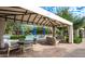 Outdoor cabana with comfortable seating near the splash pad provides a relaxing retreat at 1953 W Kinfield Trl, Phoenix, AZ 85085