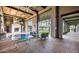 Indoor/outdoor clubhouse with open brick design, seating, fireplace, ping pong table and manicured lawn at 1953 W Kinfield Trl, Phoenix, AZ 85085
