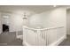 Upstairs hallway with bright lighting and decorative railing overlooking the first floor at 1953 W Kinfield Trl, Phoenix, AZ 85085