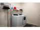 Well-equipped laundry room with modern washer, dryer, and shelving at 1953 W Kinfield Trl, Phoenix, AZ 85085