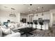 Bright living space with open layout features modern lighting, kitchen island, and comfortable seating at 1953 W Kinfield Trl, Phoenix, AZ 85085