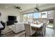 Bright living room with dining area, comfortable seating, and sliding glass doors to outdoor space at 1953 W Kinfield Trl, Phoenix, AZ 85085