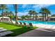 The community pool provides a relaxing spot with lounge chairs and lush landscaping at 1953 W Kinfield Trl, Phoenix, AZ 85085