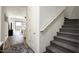 Well-lit stairway with carpeted steps leads to the upper level at 1953 W Kinfield Trl, Phoenix, AZ 85085