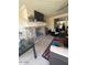 Cozy covered patio with a stone fireplace and comfortable seating area at 2120 N 166Th Dr, Goodyear, AZ 85395