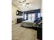 Relaxing bedroom with a ceiling fan, large television, and luxury vinyl flooring at 2135 W Vineyard Rd, Phoenix, AZ 85041