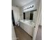 Bathroom featuring a double sink vanity with quartz countertop, tile floor and updated fixtures at 21443 N 29Th Dr, Phoenix, AZ 85027