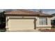 Beige home showcasing a two car garage, red tile roof and desert landscaping at 21443 N 29Th Dr, Phoenix, AZ 85027