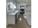 Bright and open kitchen with white cabinets, quartz countertops and a stainless steel range at 21443 N 29Th Dr, Phoenix, AZ 85027