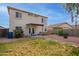 Backyard featuring a well-maintained lawn, patio area, and fire pit at 22644 W Mohave St, Buckeye, AZ 85326