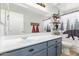 Updated bathroom with single vanity, modern faucet, and shower/tub combo with stylish decor and a large mirror at 22644 W Mohave St, Buckeye, AZ 85326