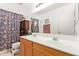 Bathroom featuring double sinks, a large mirror, and decorative shower curtain, adding style and functionality at 22644 W Mohave St, Buckeye, AZ 85326