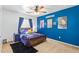 This charming bedroom has a modern ceiling fan, a cozy bed, and vibrant wall decor at 22644 W Mohave St, Buckeye, AZ 85326
