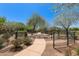 Scenic community park featuring walking paths, lush greenery, and inviting benches under a clear blue sky at 22644 W Mohave St, Buckeye, AZ 85326