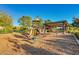 Community playground with slide, swings, and shaded picnic area for Gathering fun at 22644 W Mohave St, Buckeye, AZ 85326