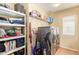 Well-lit laundry room featuring modern washer and dryer, shelving units, and storage solutions at 22644 W Mohave St, Buckeye, AZ 85326