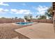 A beautiful backyard with a pool, slide, and lush gravel landscape for outdoor enjoyment at 28014 N Jade St, San Tan Valley, AZ 85143