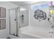 Modern bathroom with a glass-enclosed shower, soaking tub, and elegant decor at 28014 N Jade St, San Tan Valley, AZ 85143