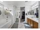 Bathroom featuring a soaking tub, double vanity, and sliding door to the walk-in closet at 28014 N Jade St, San Tan Valley, AZ 85143