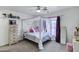 Bright bedroom featuring a four-poster canopy bed with sheer curtains and soft furnishings at 28014 N Jade St, San Tan Valley, AZ 85143