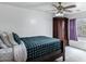 This bedroom features a ceiling fan, wardrobe, and window with stylish purple curtains at 28014 N Jade St, San Tan Valley, AZ 85143