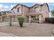 Two-story home with neutral stucco, tiled roof, and a desert landscape at 28014 N Jade St, San Tan Valley, AZ 85143
