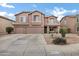 Traditional two-story home with stucco exterior and a large driveway at 28014 N Jade St, San Tan Valley, AZ 85143