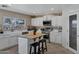 Well-lit kitchen with white cabinetry, stainless steel appliances, and a center island at 28014 N Jade St, San Tan Valley, AZ 85143