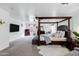 Bright main bedroom with dark furniture, sitting area, and ample natural light at 28014 N Jade St, San Tan Valley, AZ 85143