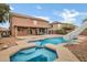View of a pool with slide and spa, perfect for outdoor relaxation and entertainment at 28014 N Jade St, San Tan Valley, AZ 85143