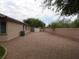 Spacious backyard featuring a gravel ground cover, a brick fence, and a storage shed at 29673 N 120Th Ln, Peoria, AZ 85383