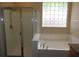 Modern bathroom with a soaking tub and a separate shower, with granite counters at 29673 N 120Th Ln, Peoria, AZ 85383