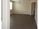 Open-concept living room featuring wood floors, natural lighting, and neutral walls at 29673 N 120Th Ln, Peoria, AZ 85383