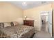 This warm bedroom features a carpeted floor, neutral paint, and a view into the living room at 30112 N Jillian Dr, San Tan Valley, AZ 85143