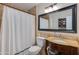 Cozy bathroom featuring a single sink vanity and tiled shower with curtain at 3041 E Roma Ave, Phoenix, AZ 85016