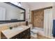 Well-lit bathroom featuring tiled wall with a vanity sink and shower tub at 3041 E Roma Ave, Phoenix, AZ 85016