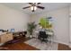 Bright bedroom with a ceiling fan and a window providing natural light to a work area at 3041 E Roma Ave, Phoenix, AZ 85016