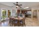 Bright kitchen and dining space with stainless steel appliances, granite countertops, and an adjacent breakfast bar at 3041 E Roma Ave, Phoenix, AZ 85016