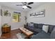 Cozy living room featuring a comfortable sofa, hardwood floors and a ceiling fan at 3041 E Roma Ave, Phoenix, AZ 85016